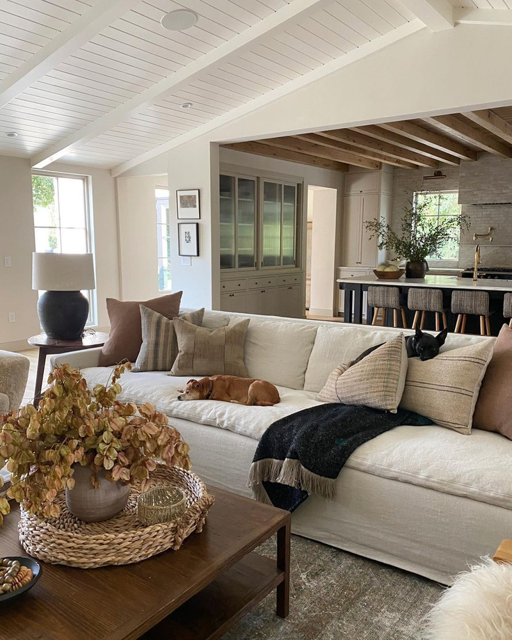 A gorgeous Amber Lewis designed living room open to the kitchen - cool California modern rustic chic style! #modernrustic #livingroom #amberlewis #californiacool #organicdecor #interiordesign
