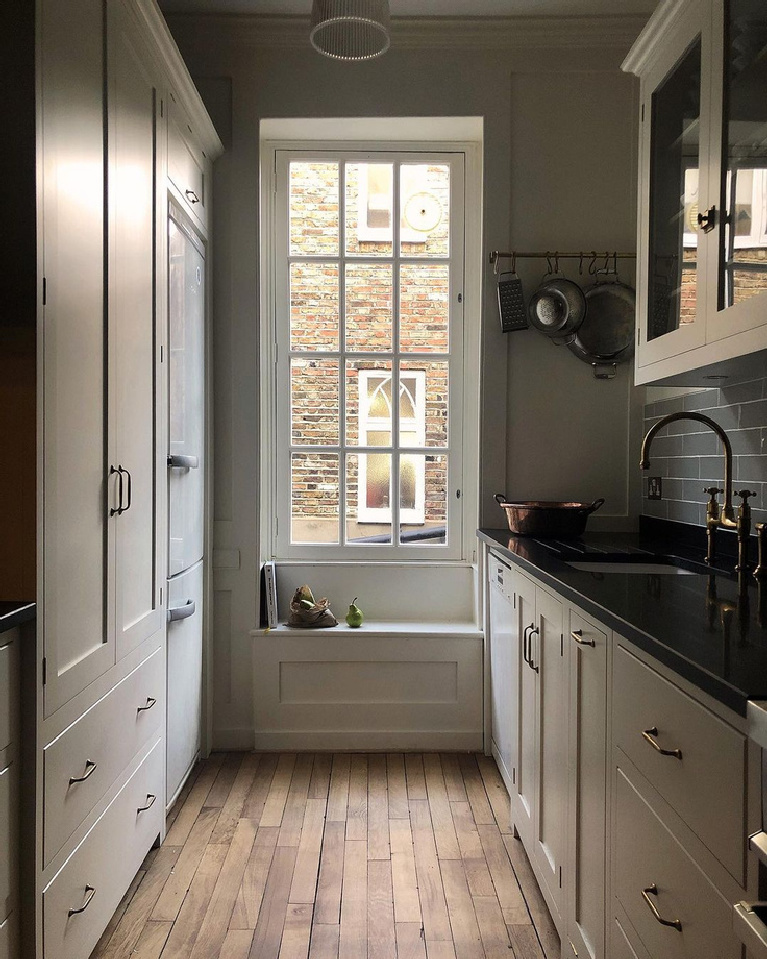 Classic English country bespoke kitchen by deVOL with tiny window seat and galley style. Find more ethereal European country kitchen moments in this collection!