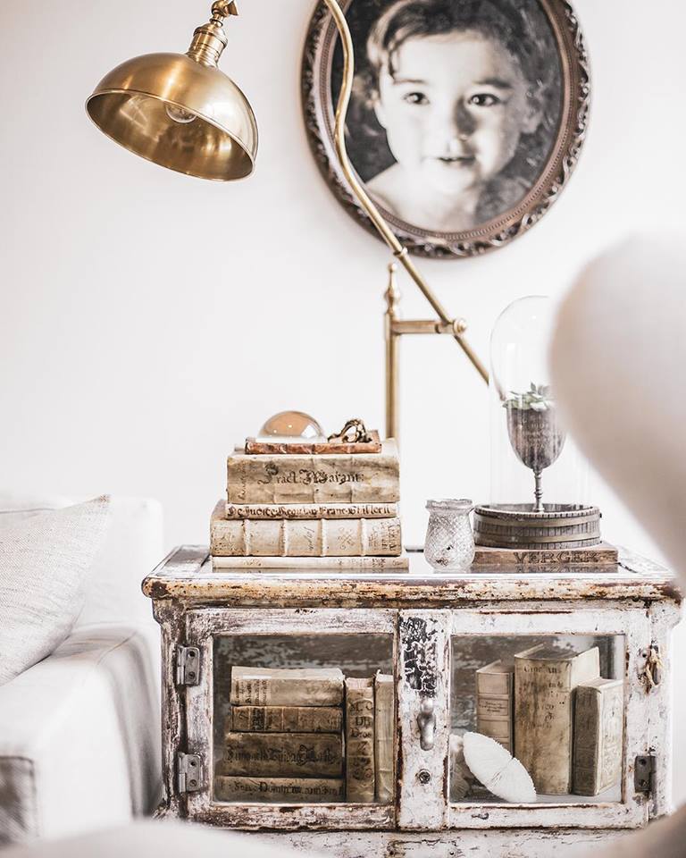 Beautiful weathered table and vellum books in a vignette by A Beautiful Mess Home.