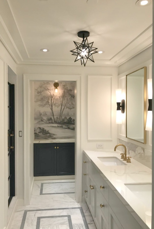 This magnificent landscape mural wallpaper in a bathroom designed by Alexander Butler made from original painting by Susan Harter. #mural #tromploeil #bathroomdesign