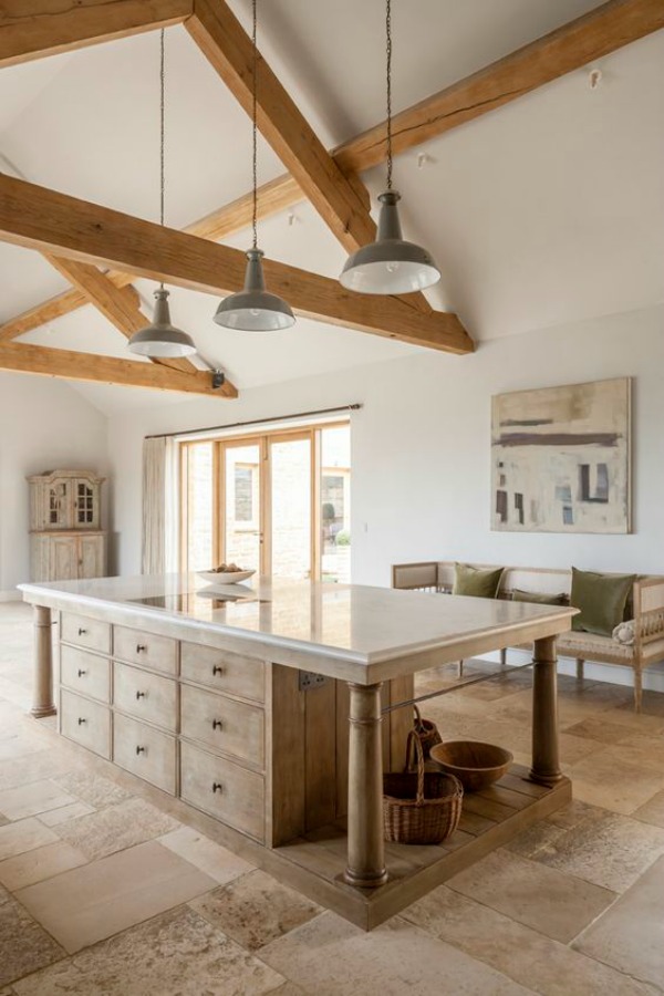 Bespoke kitchen by Artichoke with Flemish design, French farmhouse influence, stone flooring, large custom center island, and lofty ceiling.