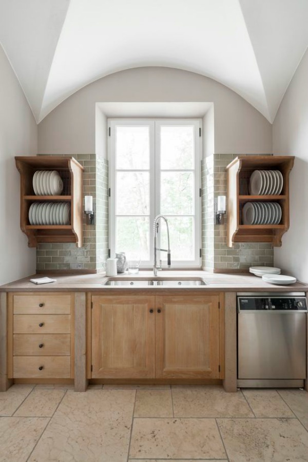 Bespoke pantry and scullery design by Artichoke for a villa in Tuscany. This scullery off the main kitchen features glazed green tile backsplash, plate racks, oak cabinetry, and magnificent arthitecture.