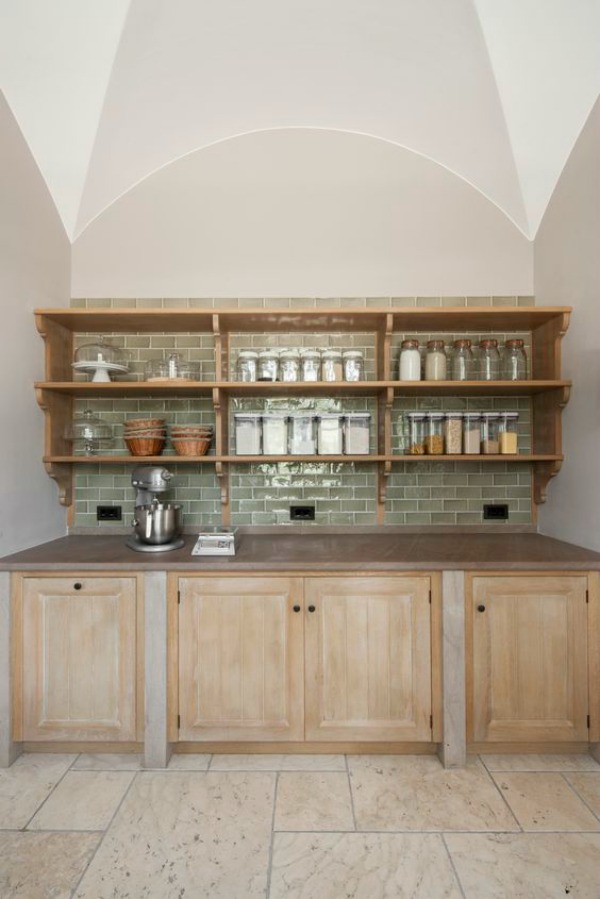 Bespoke pantry and scullery design by Artichoke for a villa in Tuscany. This scullery off the main kitchen features glazed green tile backsplash, plate racks, oak cabinetry, and magnificent arthitecture.