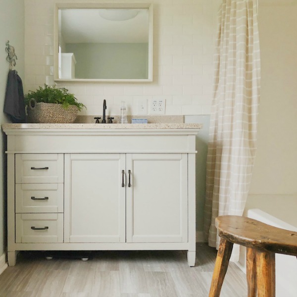 Creamy whites in bathroom with subway tile wall.