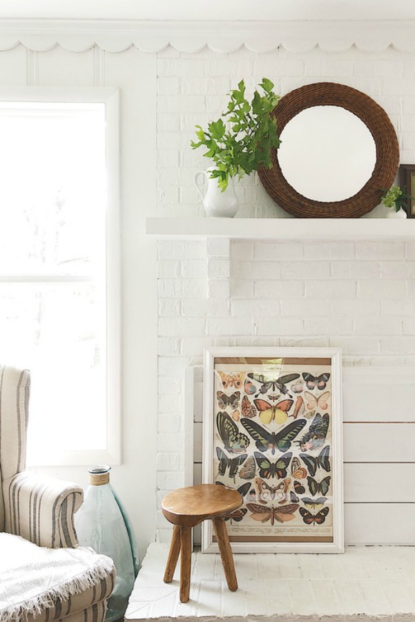 Vintage style butterfly print against white shiplap in modern farmhouse.