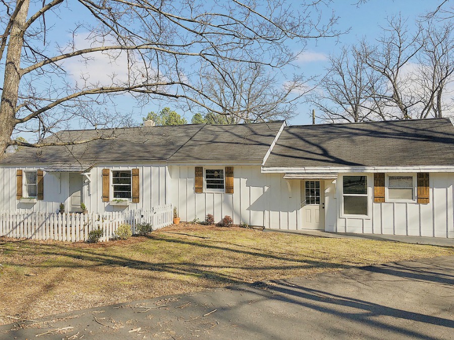 Charming white cottage in Tennessee with board and batten Hardie board siding.