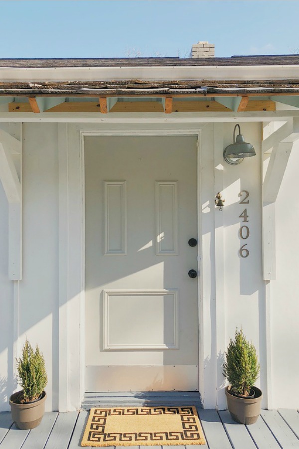 Charming cottage front door and board and batten siding.