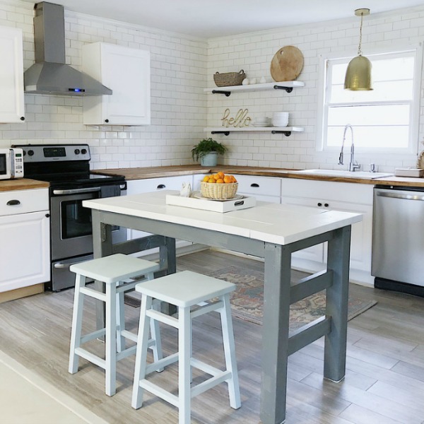 Simple white modern farmhouse kitchen with subway tile and work island in a Tennessee kitchen.