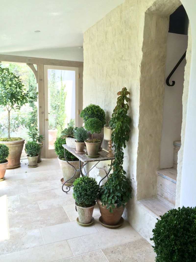 Garden room with rustic stone walls at Patina Farm by Giannetti Home.