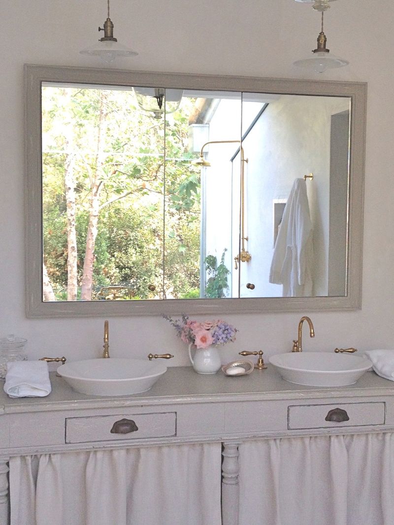 Patina Farm master bathroom with repurposed antique vanity - Giannetti Home. Pale and Lovely European Country White Interiors to Inspire with photo gallery. #interiordesign #frenchcountry