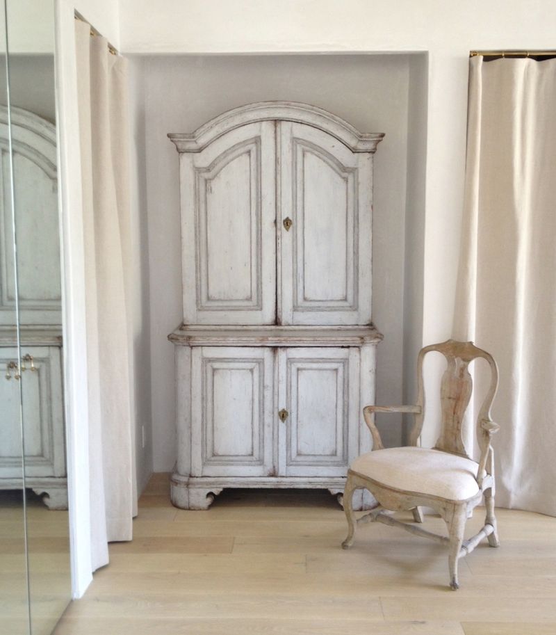 Swedish antique in Patina Farm dressing area of master bedroom. Pale and Lovely European Country White Interiors to Inspire with photo gallery. #frenchfarmhouse #interiordesign #frenchcountry