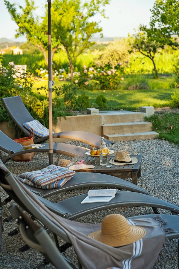 Pea gravel courtyard. Provence dreams are made of these! Come tour French Farmhouse Design: Provence Villa Photos in a story with rustic decor, Country French charm, and South of France beauty! #frenchfarmhouse #interiordesign #housetour #frenchcountry #provence