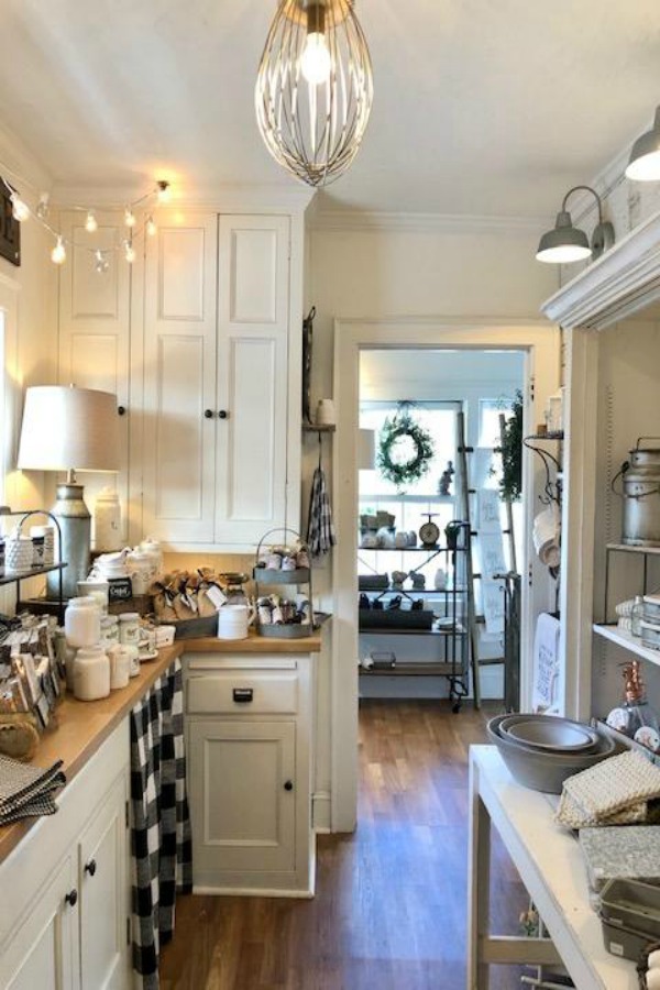 Farmhouse kitchen with white cabinets and black and white decor accents. #urbanfarmgirl