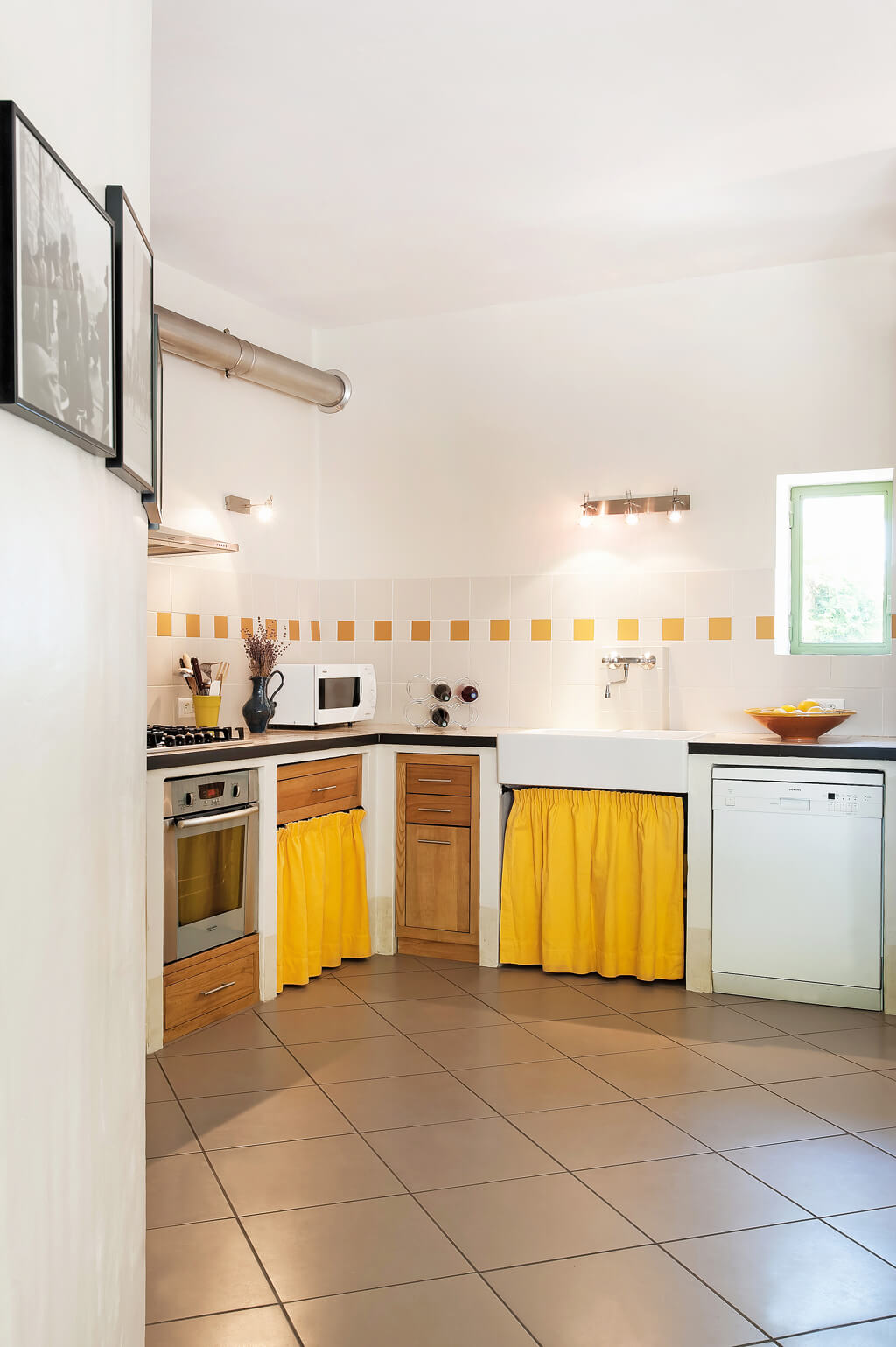 Charming Provence kitchen with bright sunshine yellow skirted sink and accents - Haven In. #frenchkitchen #frenchcountry #brightyellow