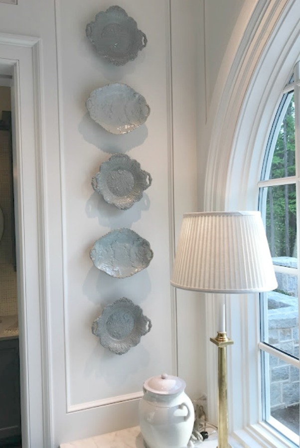 Light blue glazed plates hung decoratively on the wall of a classic kitchen in Atlanta by Design Galleria and Lauren DeLoach.