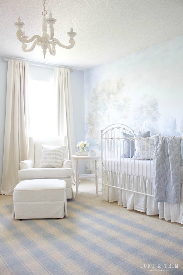 Magnificent landscape mural wallpaper in nursery designed by Tuft & Trim made from original painting by Susan Harter. Muted and sophisticated colors in this beautifully inspiring interior design. #mural #interiordesign #timeless #ethereal #serenedecor #paintedmural #wallpaper