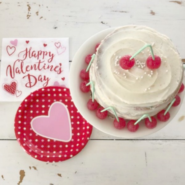 Vintage Valentine Decorations & Layer Cake. Come find simple inspiration for EASY, old fashioned, heart and love themed ideas like this simple layer cake with cherry lollipops and vintage cards on Hello Lovely Studio. #valentinesday #decorations #tablescape #layercake #vintagevalentinecards