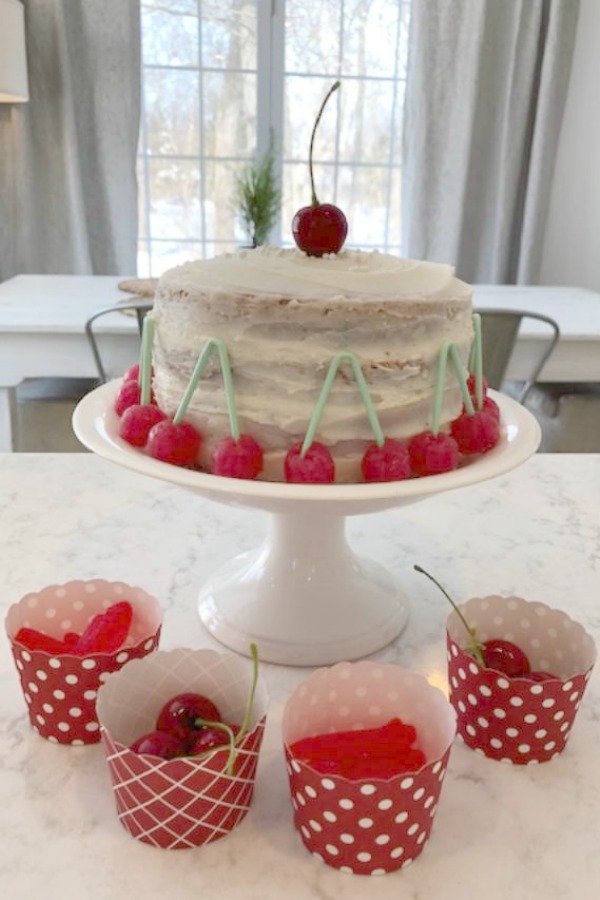 Vintage Valentine Decorations & Layer Cake. Come find simple inspiration for EASY, old fashioned, heart and love themed ideas like this simple layer cake with cherry lollipops and vintage cards on Hello Lovely Studio. #valentinesday #decorations #tablescape #layercake #vintagevalentinecards