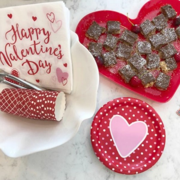 Vintage Valentine Decorations & Layer Cake. Come find simple inspiration for EASY, old fashioned, heart and love themed ideas like this simple layer cake with cherry lollipops and vintage cards on Hello Lovely Studio. #valentinesday #decorations #tablescape #layercake #vintagevalentinecards