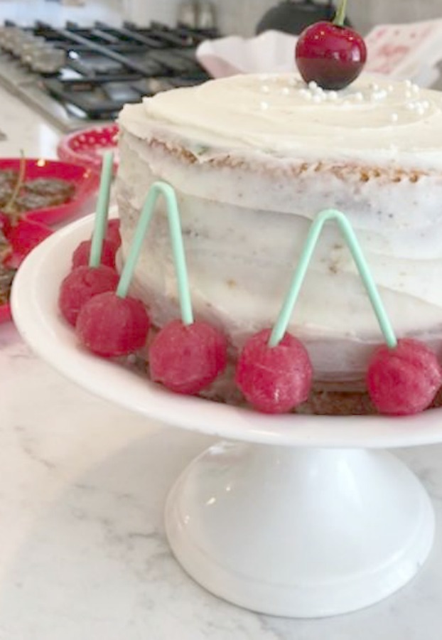 Vintage Valentine Decorations & Layer Cake. Come find simple inspiration for EASY, old fashioned, heart and love themed ideas like this simple layer cake with cherry lollipops and vintage cards on Hello Lovely Studio. #valentinesday #decorations #tablescape #layercake #vintagevalentinecards