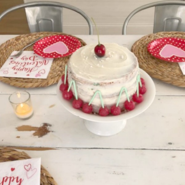 Vintage Valentine Decorations & Layer Cake. Come find simple inspiration for EASY, old fashioned, heart and love themed ideas like this simple layer cake with cherry lollipops and vintage cards on Hello Lovely Studio. #valentinesday #decorations #tablescape #layercake #vintagevalentinecards