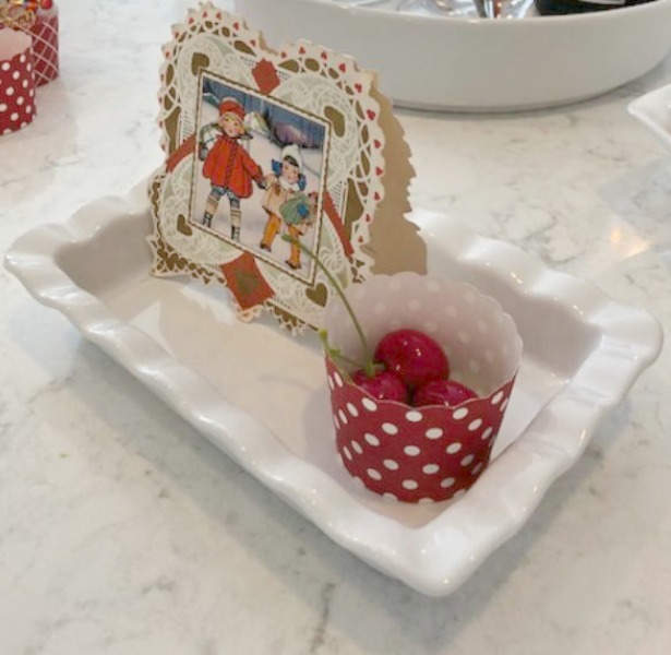 Vintage Valentine Decorations & Layer Cake. Come find simple inspiration for EASY, old fashioned, heart and love themed ideas like this simple layer cake with cherry lollipops and vintage cards on Hello Lovely Studio. #valentinesday #decorations #tablescape #layercake #vintagevalentinecards