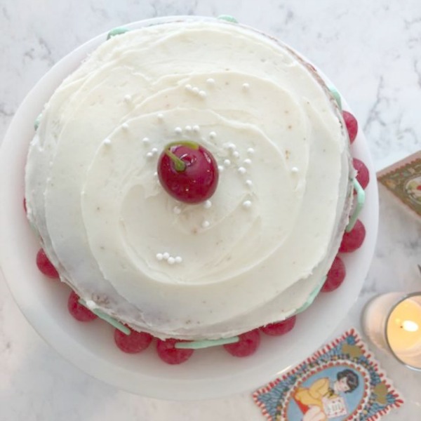 Vintage Valentine Decorations & Layer Cake. Come find simple inspiration for EASY, old fashioned, heart and love themed ideas like this simple layer cake with cherry lollipops and vintage cards on Hello Lovely Studio. #valentinesday #decorations #tablescape #layercake #vintagevalentinecards