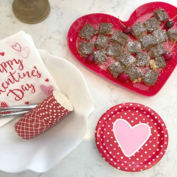 Vintage Valentine Decorations & Layer Cake. Come find simple inspiration for EASY, old fashioned, heart and love themed ideas like this simple layer cake with cherry lollipops and vintage cards on Hello Lovely Studio. #valentinesday #decorations #tablescape #layercake #vintagevalentinecards