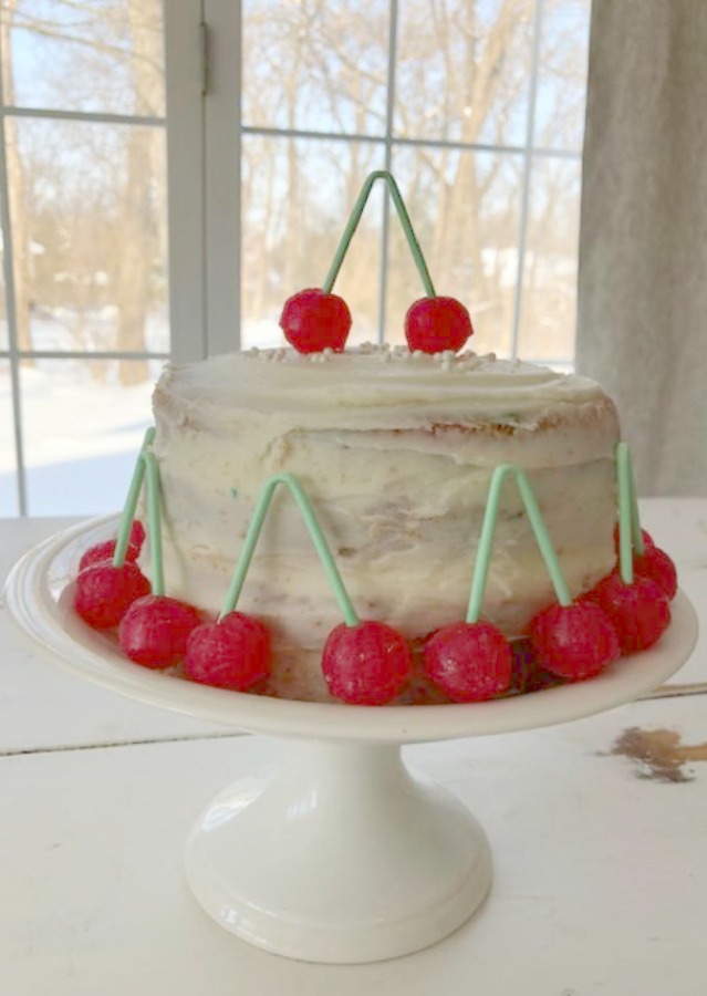 Vintage Valentine Decorations & Layer Cake. Come find simple inspiration for EASY, old fashioned, heart and love themed ideas like this simple layer cake with cherry lollipops and vintage cards on Hello Lovely Studio. #valentinesday #decorations #tablescape #layercake #vintagevalentinecards