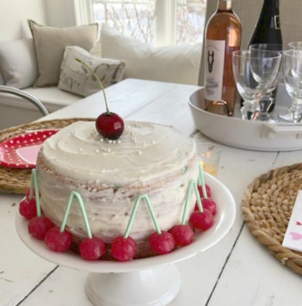 Vintage Valentine Decorations & Layer Cake. Come find simple inspiration for EASY, old fashioned, heart and love themed ideas like this simple layer cake with cherry lollipops and vintage cards on Hello Lovely Studio. #valentinesday #decorations #tablescape #layercake #vintagevalentinecards