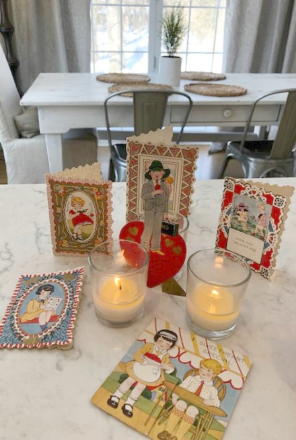 Vintage Valentine Decorations & Layer Cake. Come find simple inspiration for EASY, old fashioned, heart and love themed ideas like this simple layer cake with cherry lollipops and vintage cards on Hello Lovely Studio. #valentinesday #decorations #tablescape #layercake #vintagevalentinecards