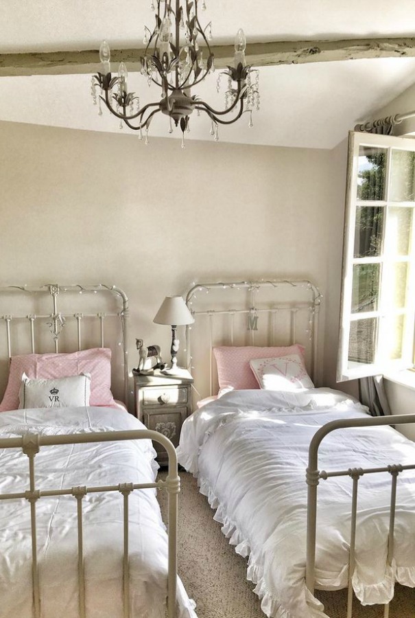 French farmhouse kids bedroom with twin metal vintage beds and walls painted Farrow & Ball Strong White.