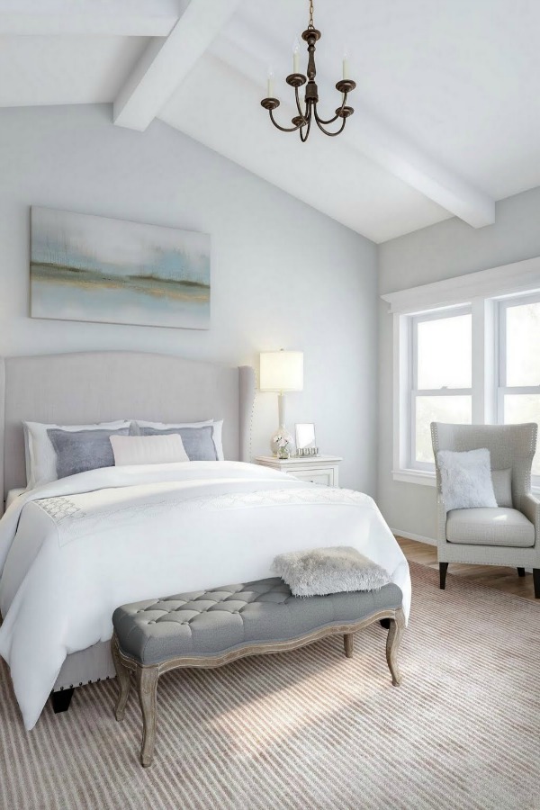 Timeless and Tranquil Bedroom Decor with blue grey walls, wingback bed, and French inspired accents. Get the look on Hello Lovely Studio!