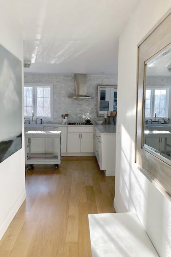 White kitchen cabinets with white oak hardwood flooring - Hello Lovely Studio.