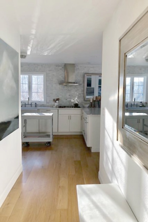 My classic white kitchen with industrial steel cart, marble backsplash, and Shaker cabinets. Hello Lovely Studio.