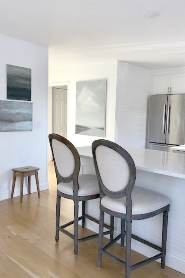 My classic white kitchen with industrial steel cart, marble backsplash, and Shaker cabinets. Hello Lovely Studio.