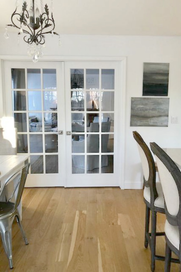 My classic white kitchen with industrial steel cart, marble backsplash, and Shaker cabinets. Hello Lovely Studio.