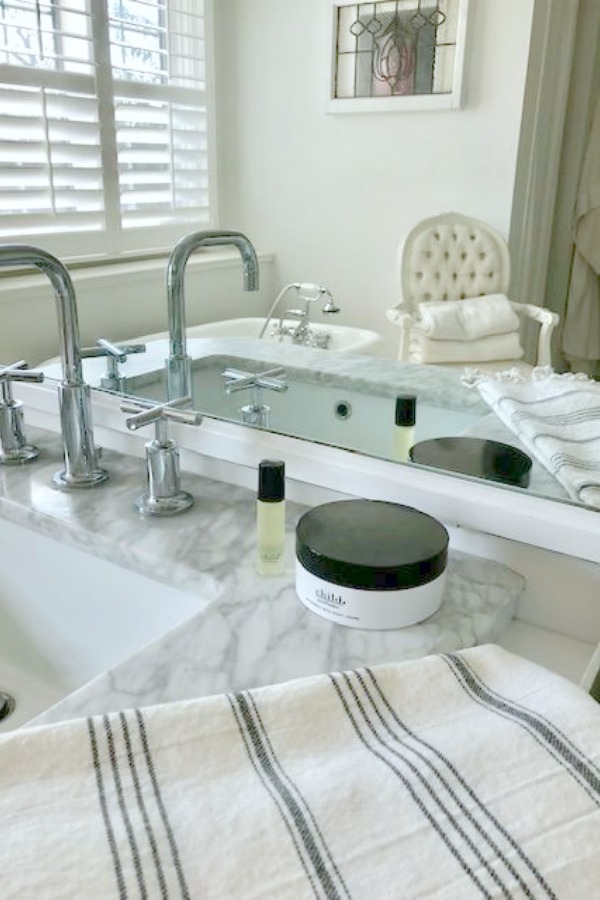 Detail of a bathroom sink vanity in a white vintage style bathroom - Hello Lovely Studio.