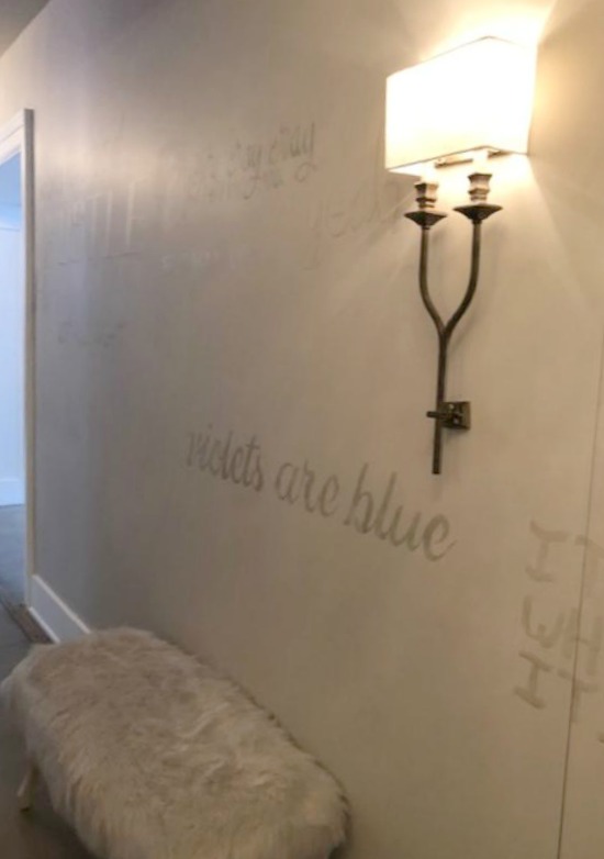 Whimsical script painted in a hallway at RH Gallery Chicago. Come tour photos of Restoration Hardware: Romantic French Decor Ideas on Hello Lovely Studio.