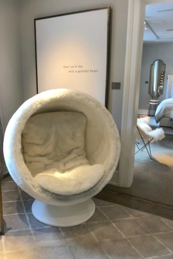 Modern egg chair with fleecy upholstery at RH Gallery Chicago. Photo: Hello Lovely Studio. Come tour photos of Restoration Hardware: Romantic French Decor Ideas on Hello Lovely Studio.