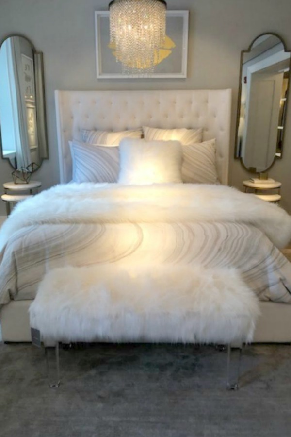 Romantic and French inspired bedroom with tufted wing style headboard at RH Gallery Chicago. Photo: Hello Lovely Studio. Come tour photos of Restoration Hardware: Romantic French Decor Ideas on Hello Lovely Studio.