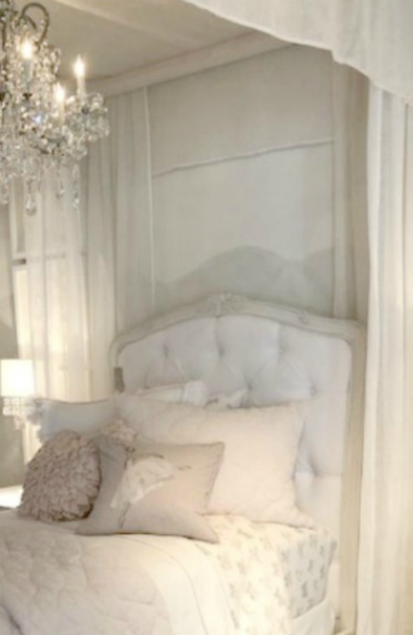 Muted tones in a RH child's French bedroom with beautiful romantic tufted headboard and canopy. Come tour photos of Restoration Hardware: Romantic French Decor Ideas on Hello Lovely Studio.