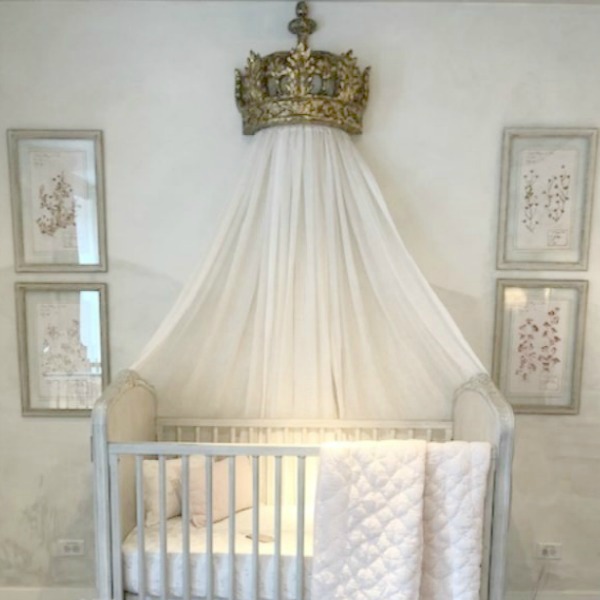 Magnificent Louis style French decor in a white nursery with canopy bed crown and furnishings by RH. Come tour photos of Restoration Hardware: Romantic French Decor Ideas on Hello Lovely Studio.