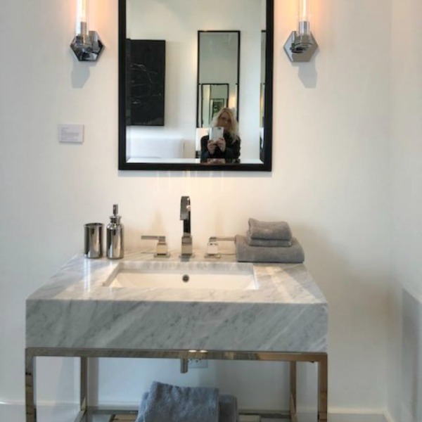 Modern console sink with marble top and metal legs from RH. Photo: Hello Lovely Studio.