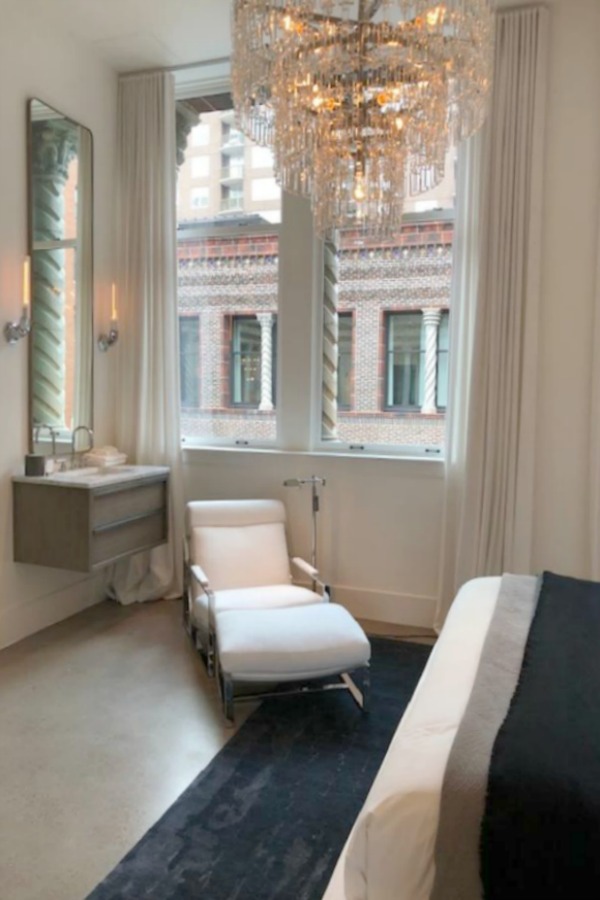 Spectacular view of architecture through a window at RH Gallery Chicago. Come tour photos of Restoration Hardware: Romantic French Decor Ideas on Hello Lovely Studio.