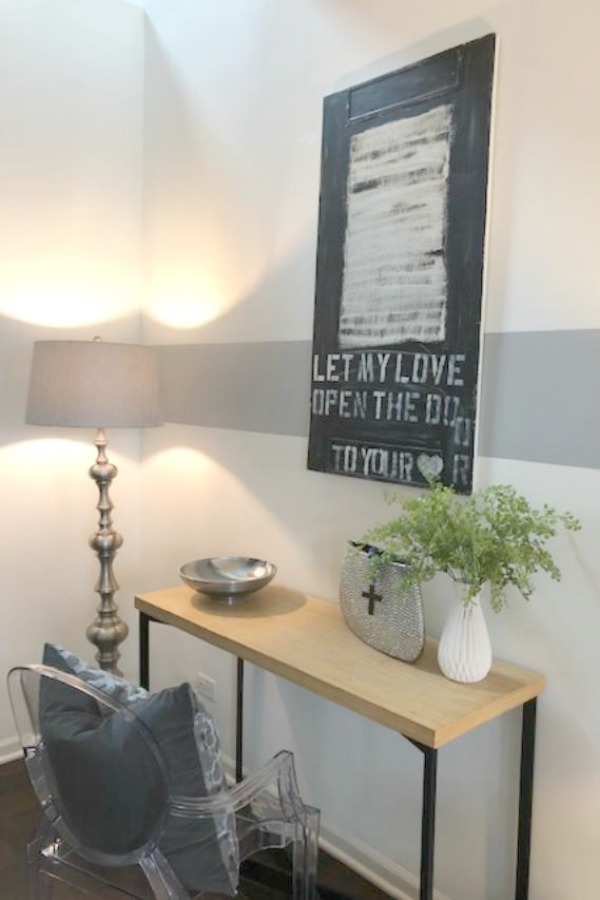 Modern rustic entry with console table, ghost chair, and art by Michele of Hello Lovely Studio.