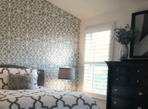 Benjamin Moore San Antonio Gray used as a paint color accent on a dramatic stenciled bedroom wall. Come visit: How to Accent Walls 3 Ways With One Paint Color on Hello Lovely Studio.