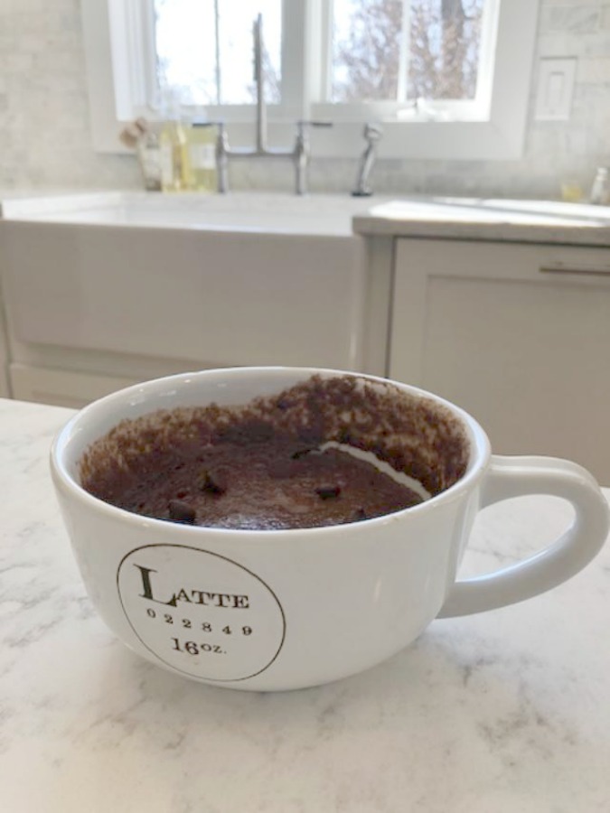 My Chocolate Minute Mug Cake in a latte mug in the kitchen - Hello Lovely Studio.