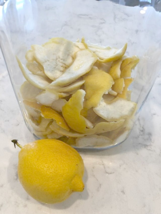 Glass jar of lemon peels ready for a limoncello recipe by Hello Lovely Studio. Countertop material is Viatera Minuet quartz.