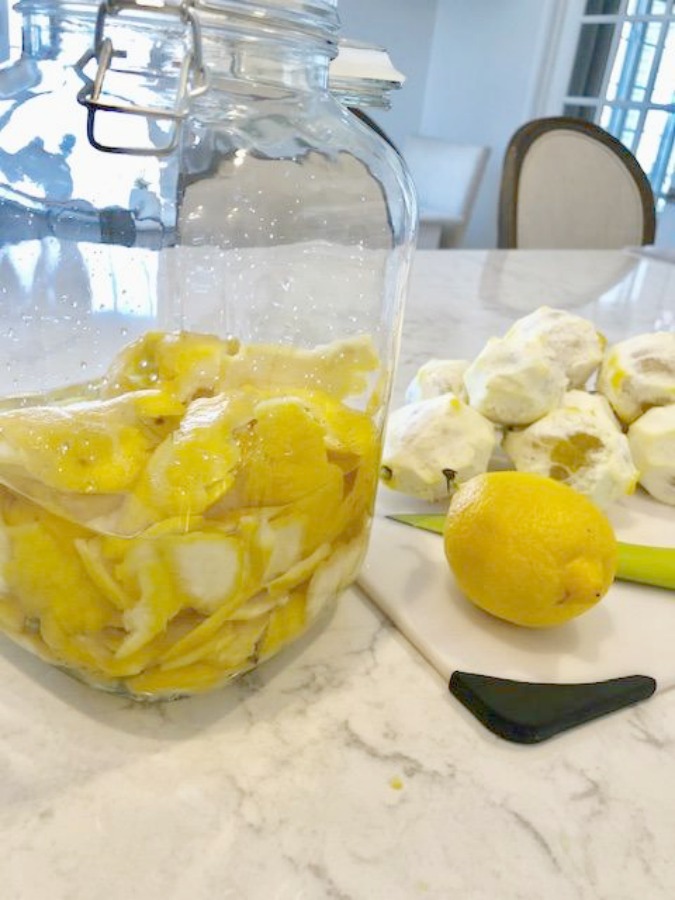 Lemon peels in jar with vodka for easy homemade limoncello recipe on Hello Lovely Studio.